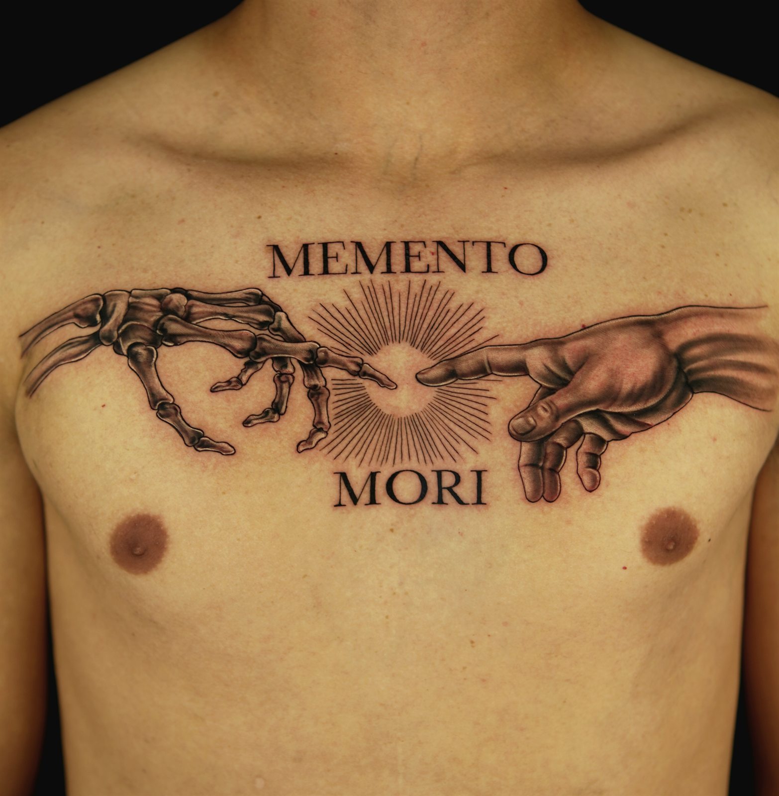 Memento Mori chest tattoo with skeletal and Michelangelo hands